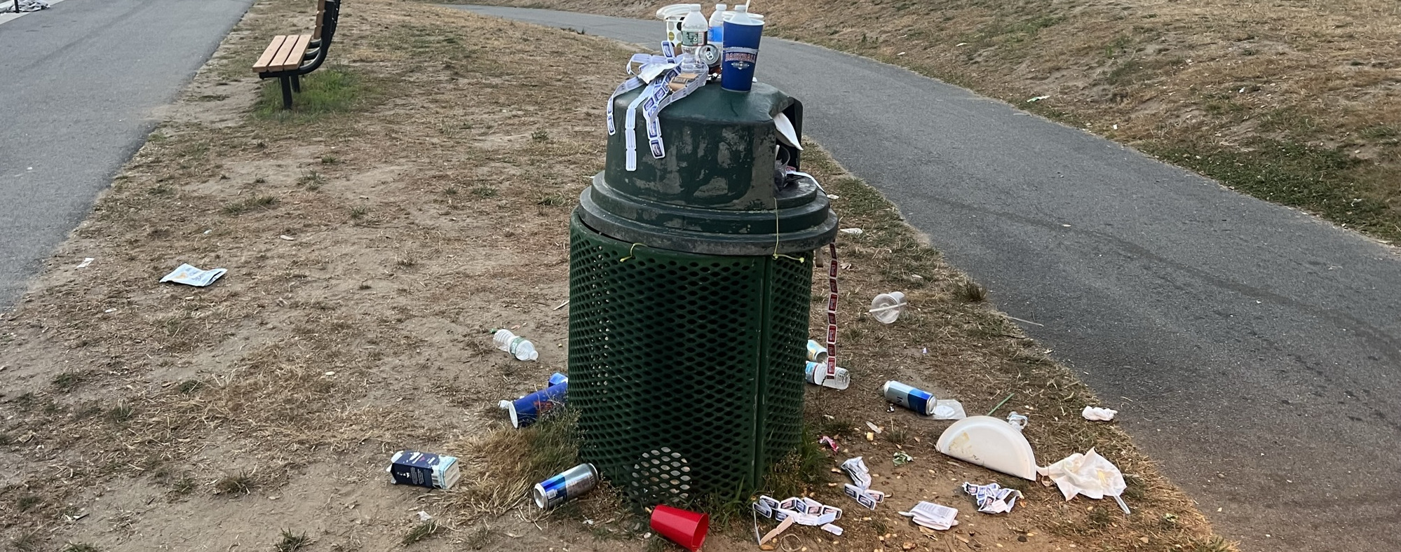 Overflowing trash can after baseball game on Cape Cod